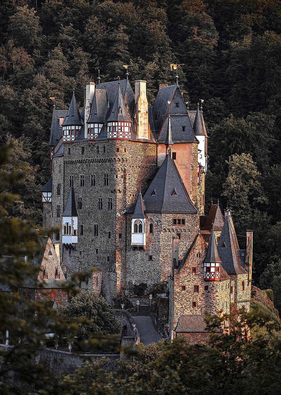 Burg Eltz framed by forested hills in Germany