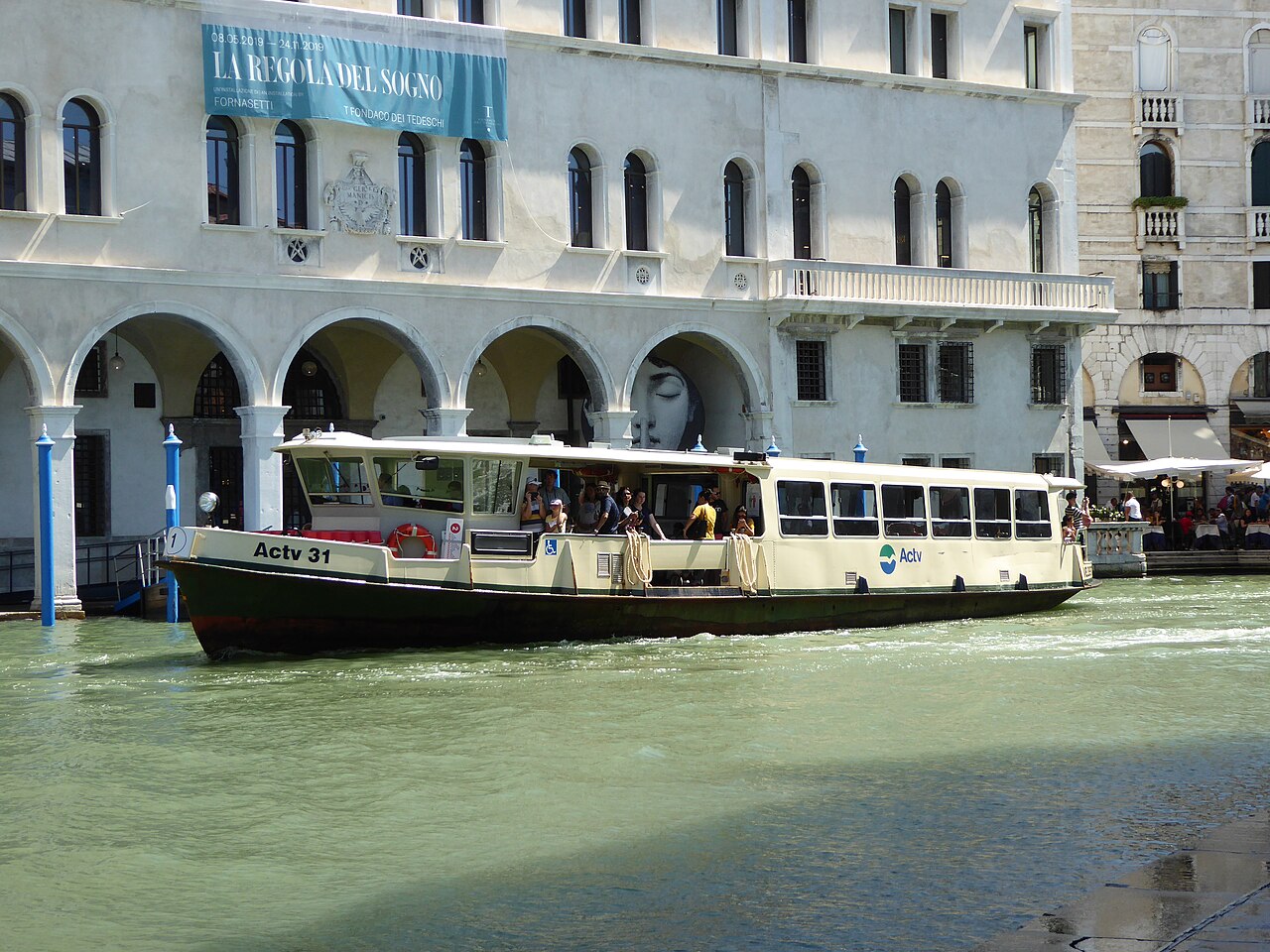A vaporetto waterbus moving through Venice