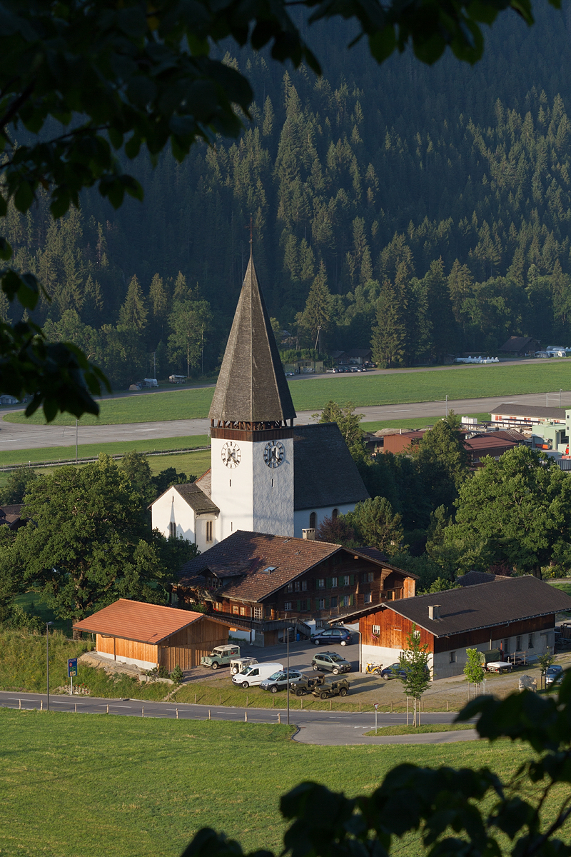St. Mauritius Church Saanen with mountain and village setting